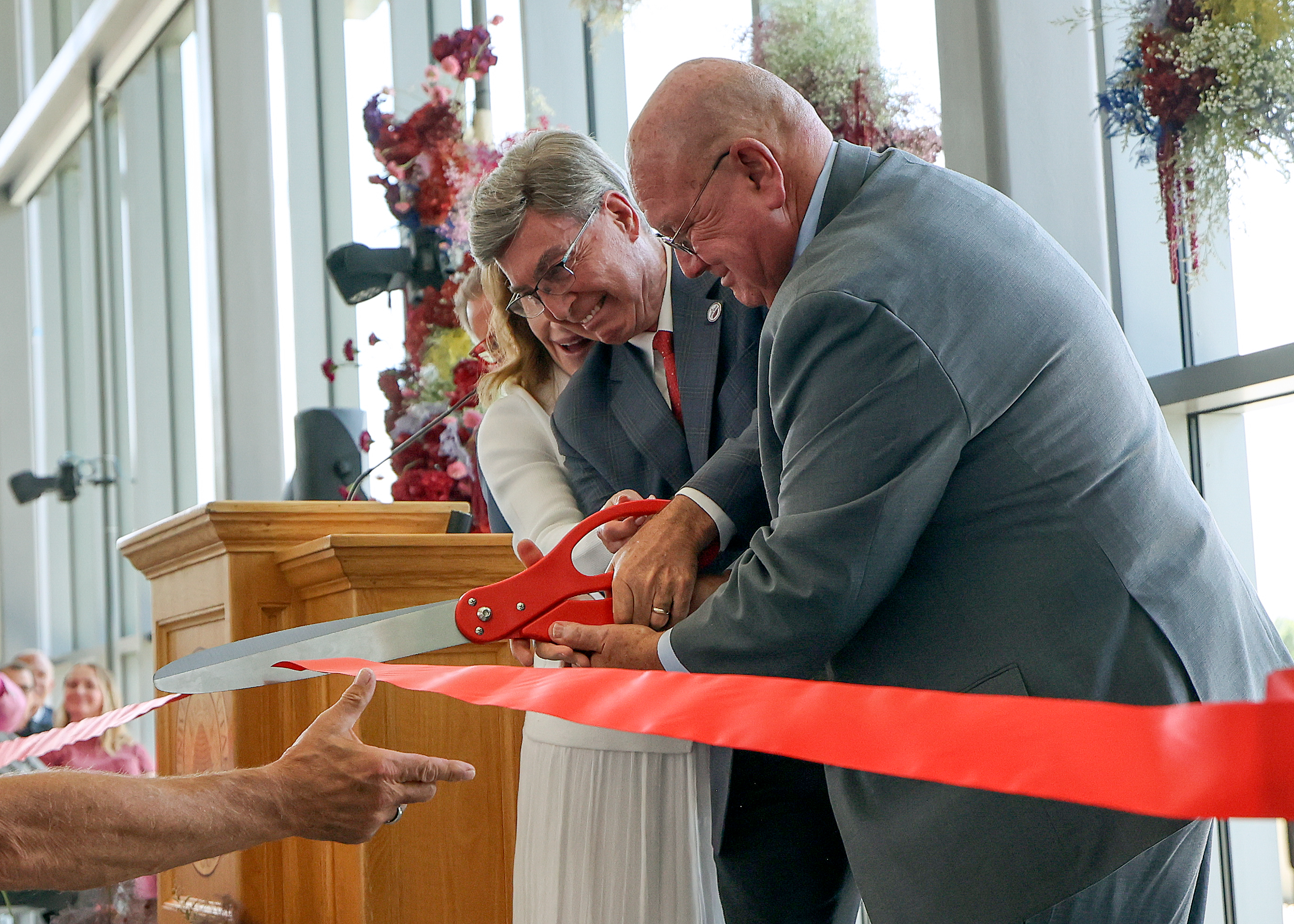 Gary Crocker, managing director of Crocker Ventures, and Mark Skaggs of the ALSAM Foundation help cut the ceremonial ribbon during a ribbon-cutting event for the L.S. Skaggs Applied Science Building at the University of Utah in Salt Lake City on Wednesday.
