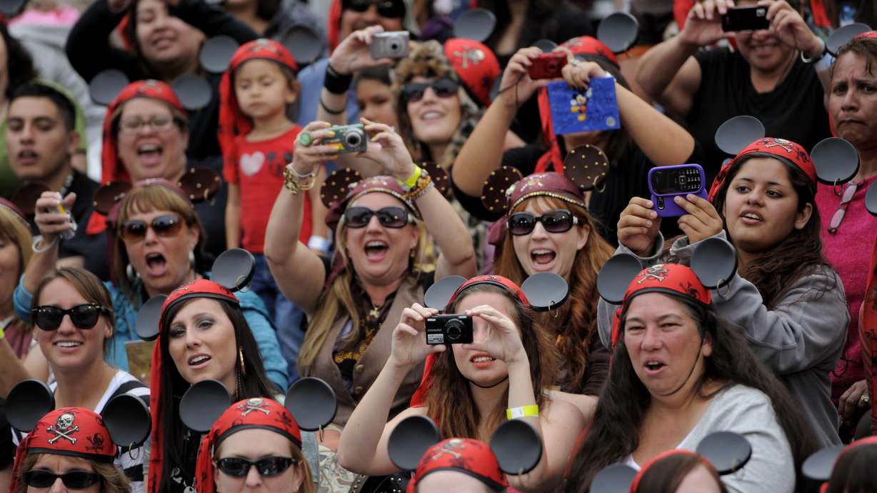 Fans cheer and take pictures as Mickey Mouse arrives at the World Premiere of "Pirates of the Caribbean: On Stranger Tides" at Disneyland in Anaheim, Calif., May 7, 2011. The park is celebrating its 70th anniversary.
