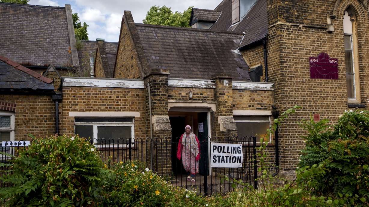 A woman exits a polling station set up at St. Anne's Church, Bermondsey, in London, on July 4, 2024. Britain plans to lower the voting age from 18 to 16 before the next national election to boost democratic participation.