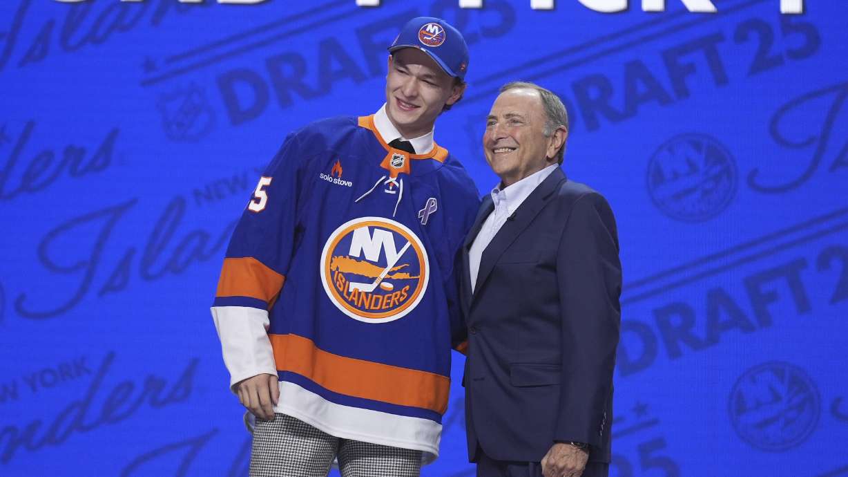 Matthew Schaefer, left, stands with NHL commissioner Gary Bettman after being drafted by the New York Islanders during the NHL hockey draft Friday, June 27, 2025, in Los Angeles.