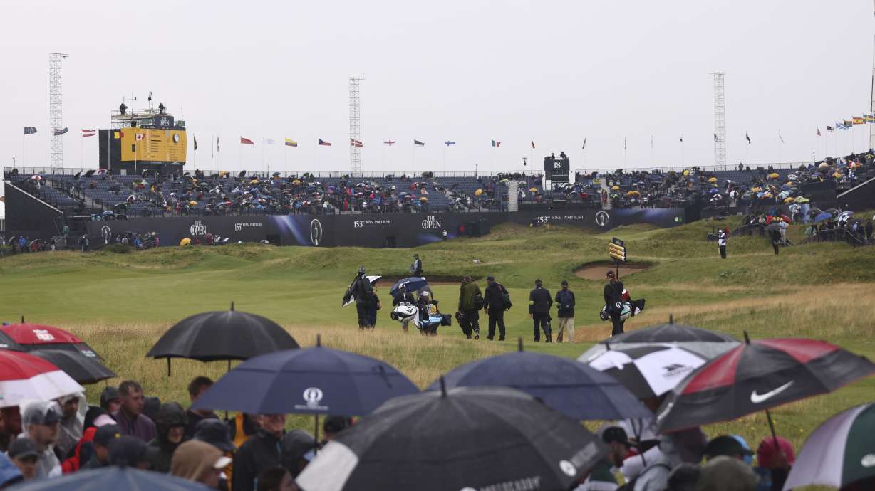 A general view of the 18th green as a group of players including Lee Westwood of England walk to the green during the first round of the British Open golf championship at the Royal Portrush Golf Club, Northern Ireland, Thursday, July 17, 2025.