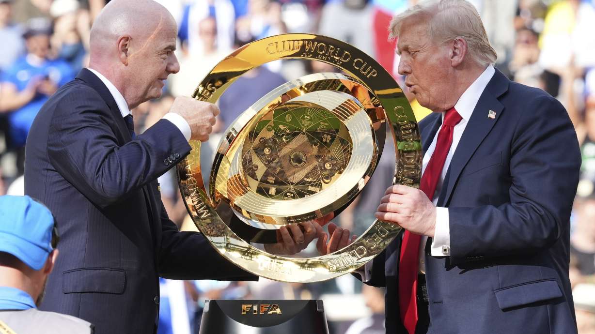 President Donald Trump, right, and FIFA President Gianni Infantino carry the championship trophy at the conclusion of the Club World Cup final soccer match at MetLife Stadium in East Rutherford, N.J., Sunday, July 13, 2025.