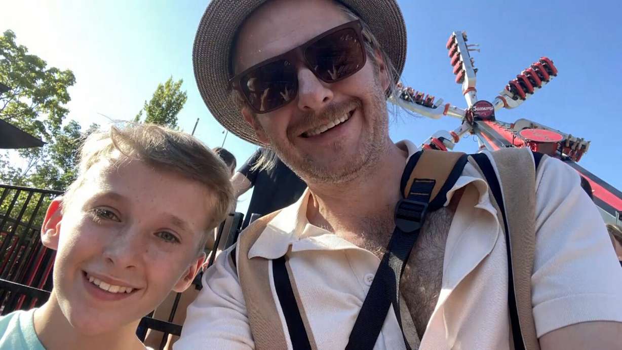 Brian Higgins and his son, Charlie, enjoy a theme park. The aftermath of post-traumatic stress disorder almost destroyed Brian Higgins in his early days after moving to the U.S.