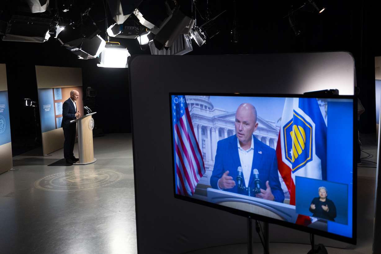 Gov. Spencer Cox responds to a reporter’s question while the broadcast is displayed during the PBS Utah Governor’s Monthly News Conference held at the Eccles Broadcast Center in Salt Lake City on Thursday.