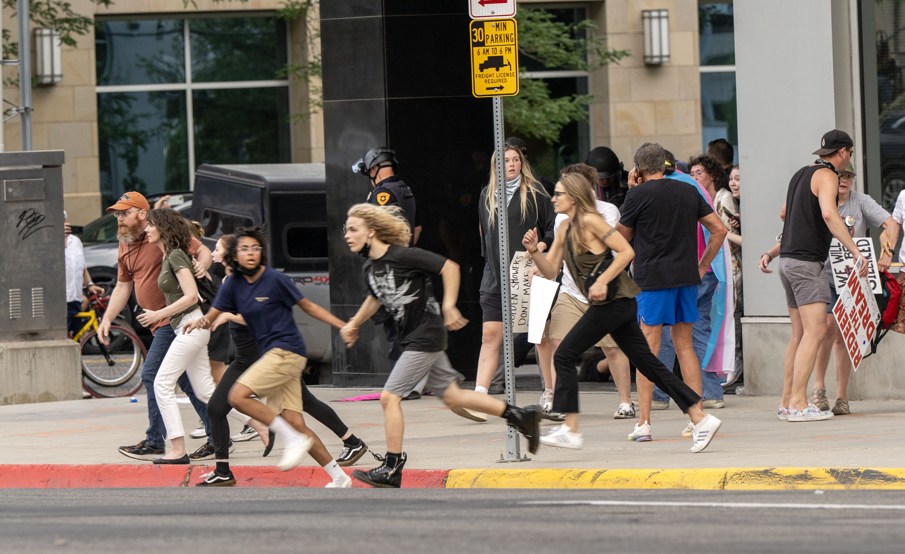 People run after reports of a shooter in Salt Lake City on June 14. Organizers behind Utah's No Kings demonstrations were warned against having armed "peacekeepers" at rallies, Gov. Spencer Cox told reporters Thursday.