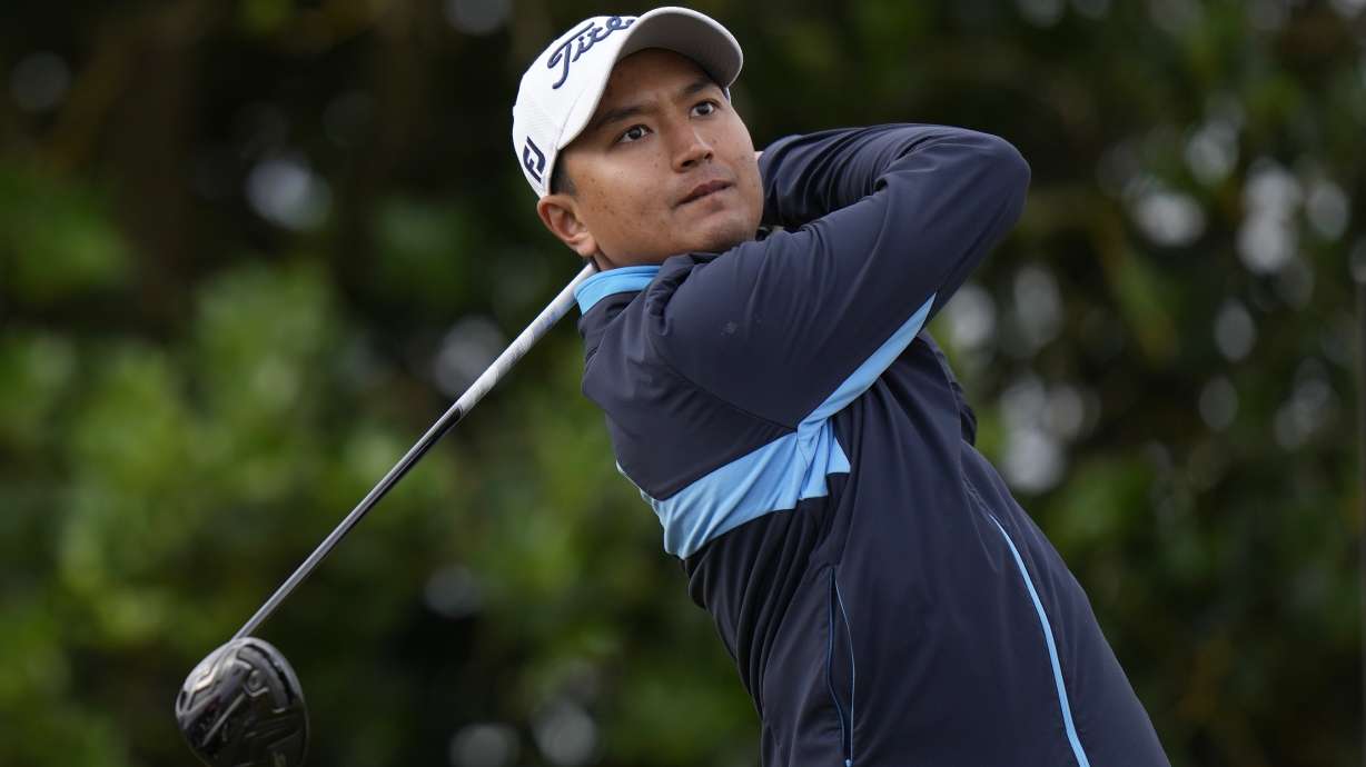 FILE - Thailand's Sadom Kaewkanjana plays from the 3rd tee during the first round of the British Open golf championship on the Old Course at St. Andrews, Scotland, July 14, 2022.