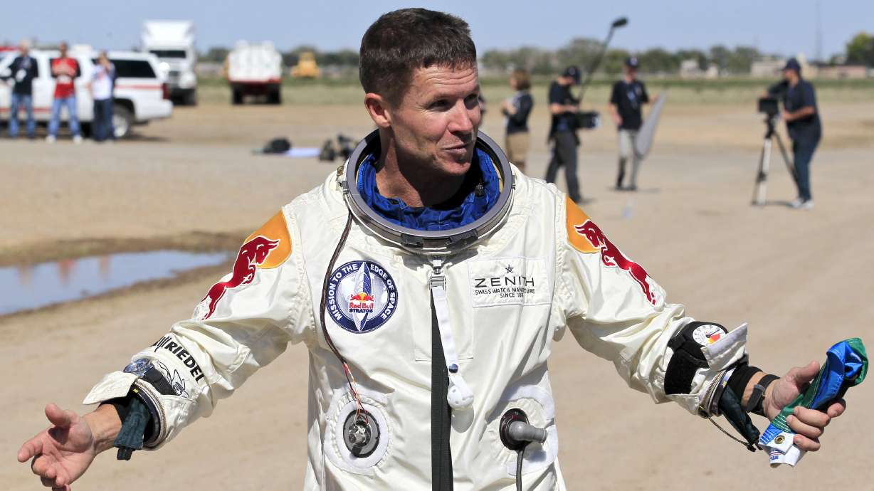 Felix Baumgartner of Austria gestures prior to speaking with the media after successfully jumping from a space capsule lifted by a helium balloon in Roswell, N.M., Oct. 14, 2012. Baumgartner died in a crash Thursday along the eastern coast of Italy.