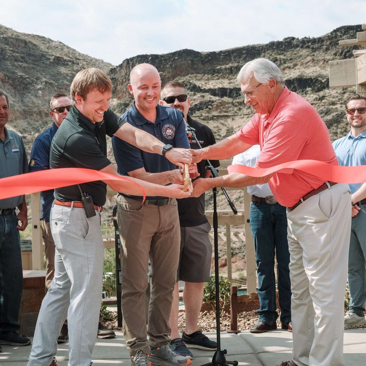 Utah Gov. Spencer Cox cuts the ribbon for the opening of Zion Canyon Hot Springs alongside the hot springs' manager Ronald Neumann, left, and La Verkin Mayor Kelly Wilson, right.