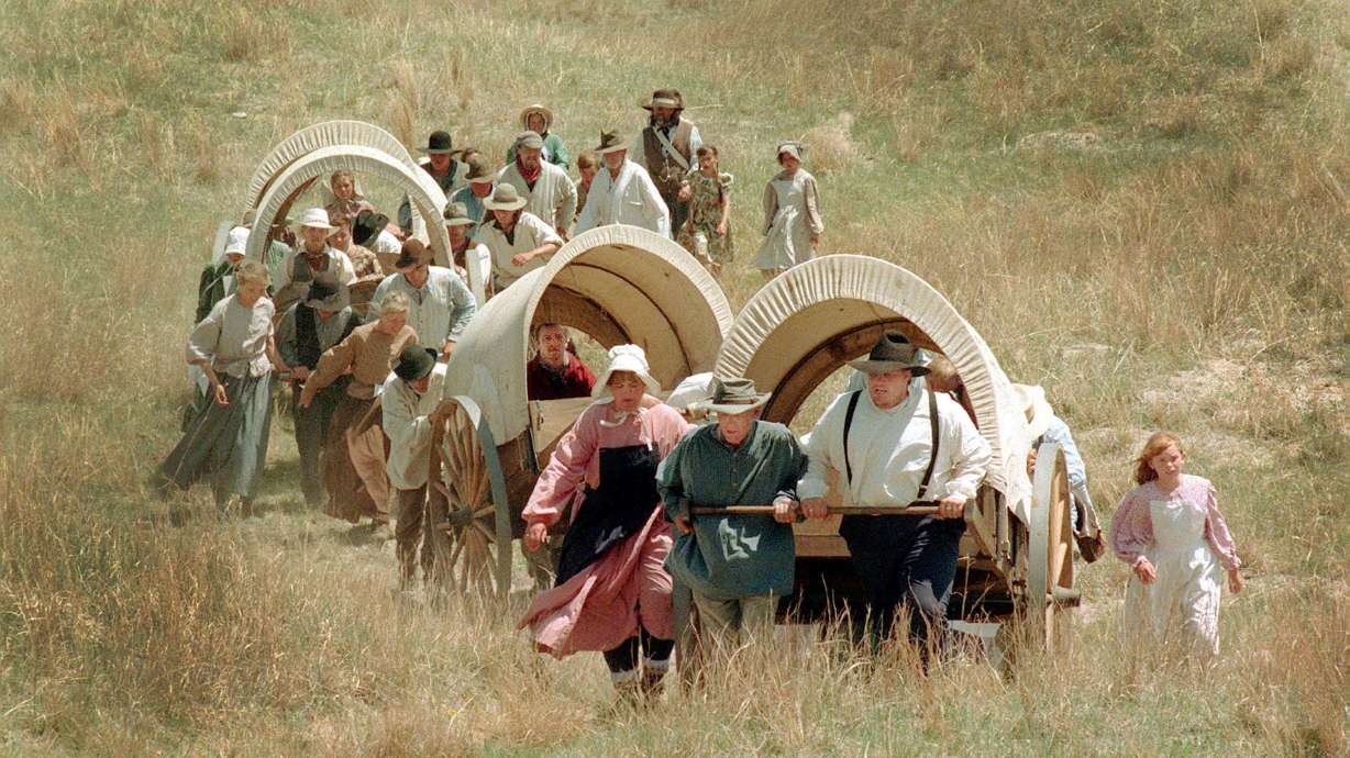 Handcart participants make their way through the original ruts of the Sand Hills of Nebraska during a Latter-day Saint pioneer trek reenactment in 1997.