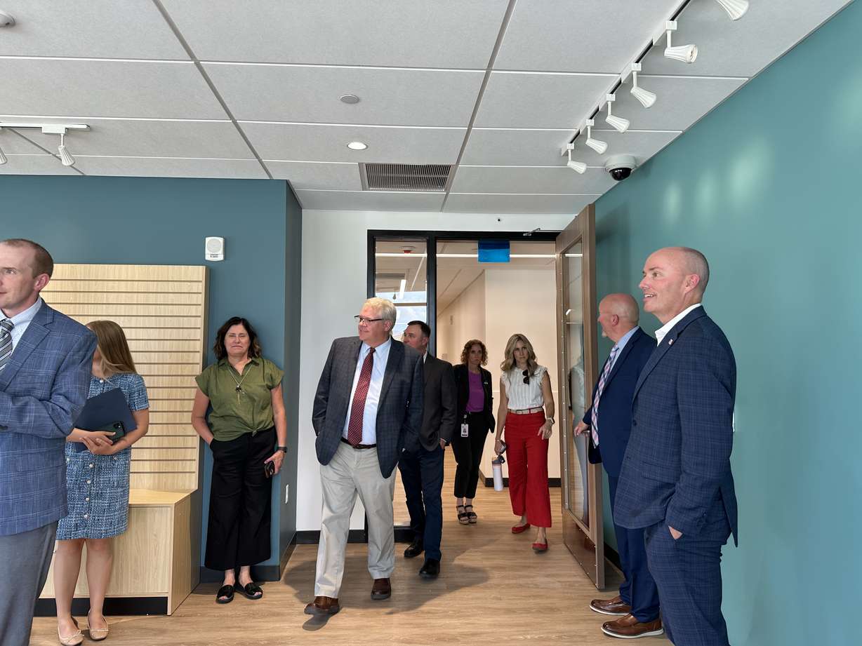 Utah State Developmental Center superintendent Tim Mathews gives Gov. Spencer Cox and others a tour of the new comprehensive therapy building at the Utah State Developmental Center in American Fork on Thursday.