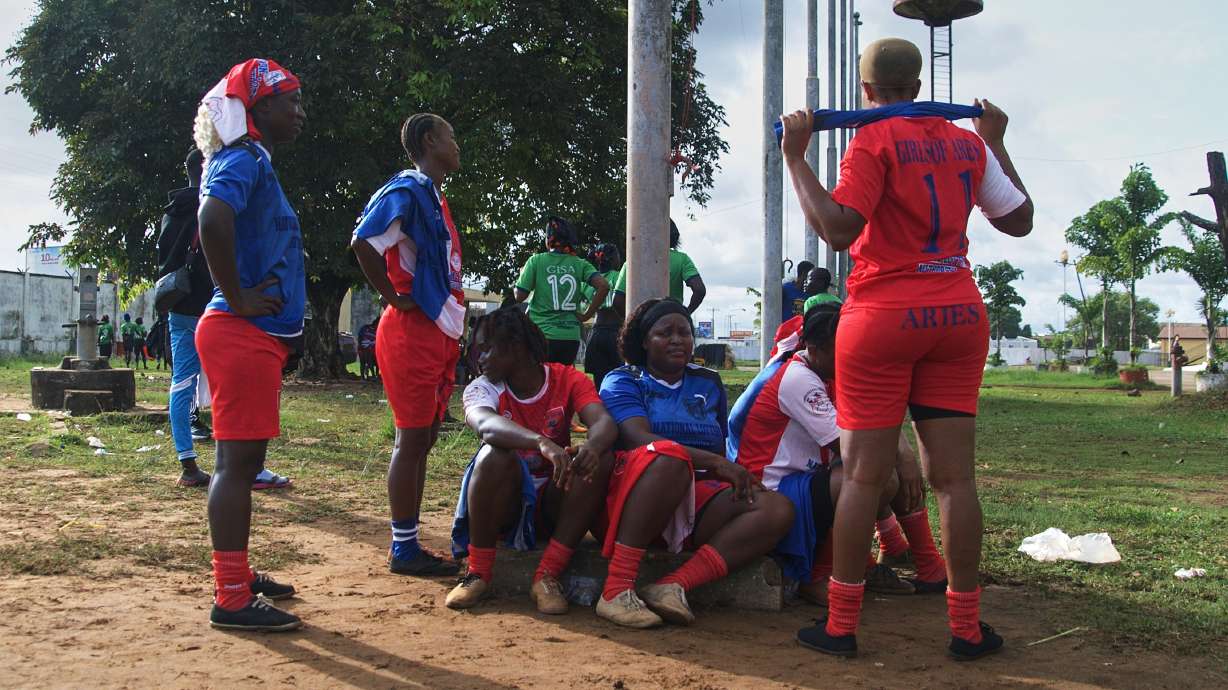 Women on the Girls of Aries kickball team, part of Liberia's professional kickball league, talk together before a match at the Samuel Kanyon Doe Stadium in Monrovia, Liberia, June 14, 2025.