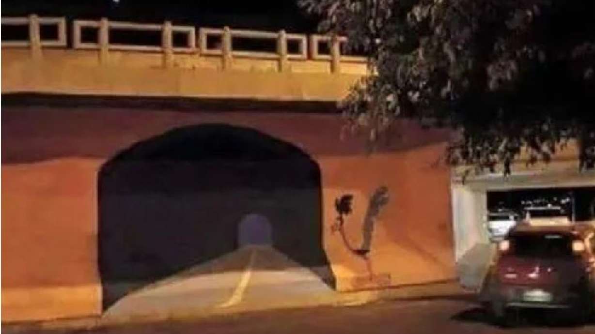 It appears someone painted a realistic-looking tunnel that went through a bridge — just like Wile E. Coyote did with the Road Runner.