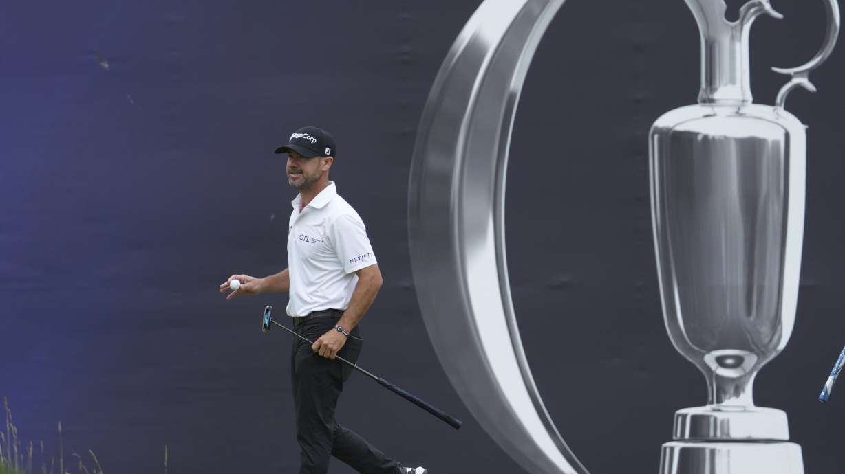 Brian Harman of the United States acknowledges the crowd after making a birdie putt on the 18th green during the second round of the British Open golf championship at the Royal Portrush Golf Club, Northern Ireland, Friday, July 18, 2025.