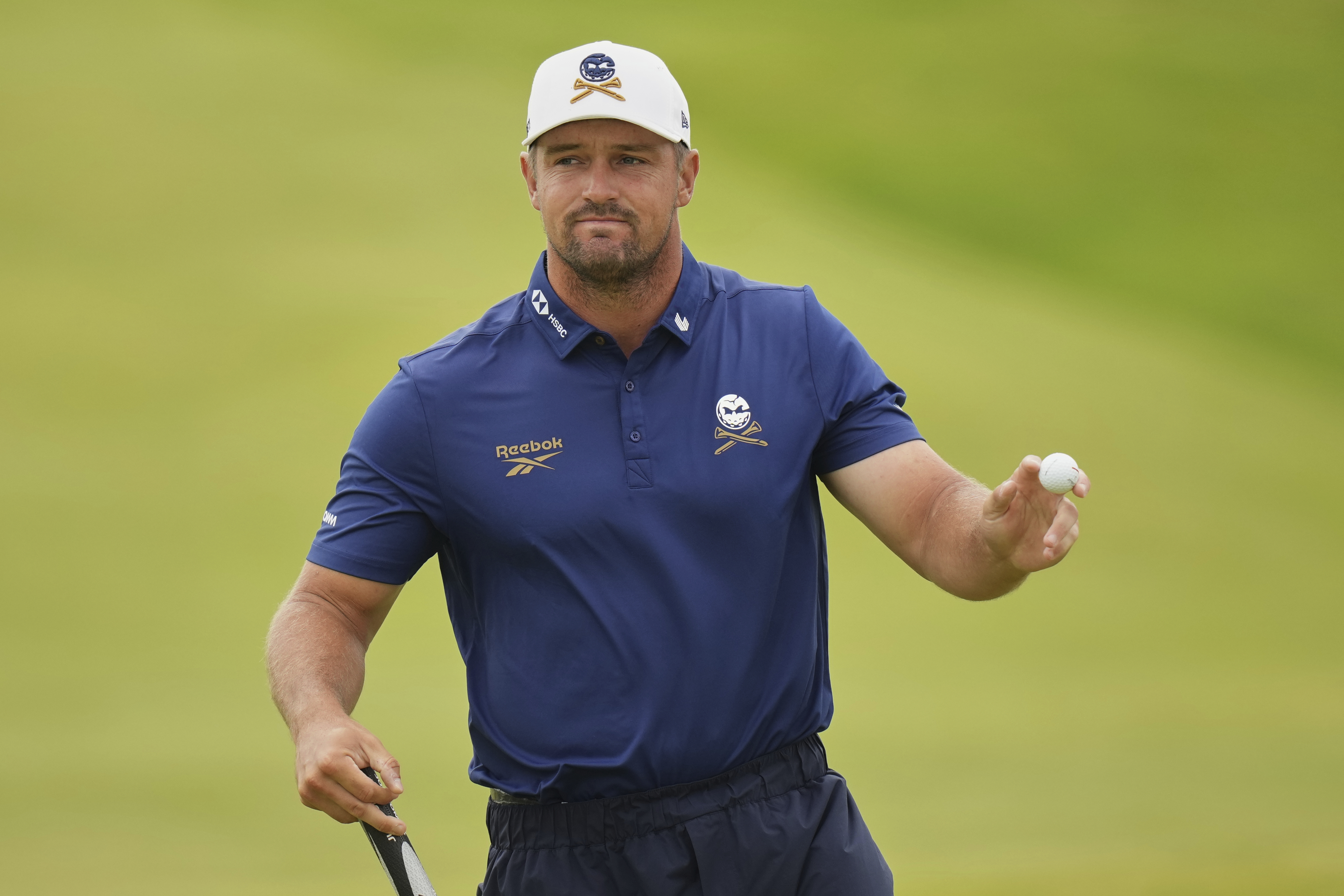 Bryson DeChambeau of the United States acknowledges the crowd on the 3rd green during the first round of the British Open golf championship at the Royal Portrush Golf Club, Northern Ireland, Thursday, July 17, 2025.