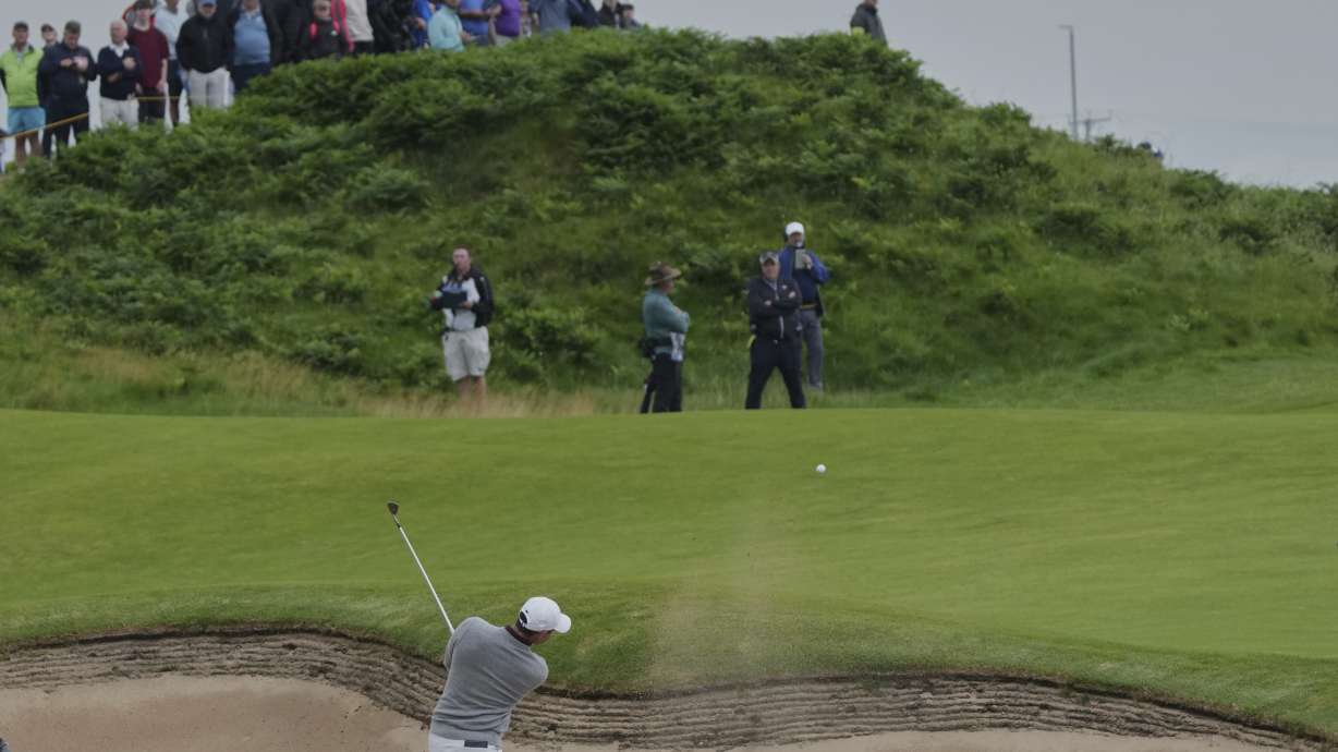 Rory McIlroy of Northern Ireland plays his second shot on12th hole from a bunker during the first round of the British Open golf championship at the Royal Portrush Golf Club, Northern Ireland, Thursday, July 17, 2025.