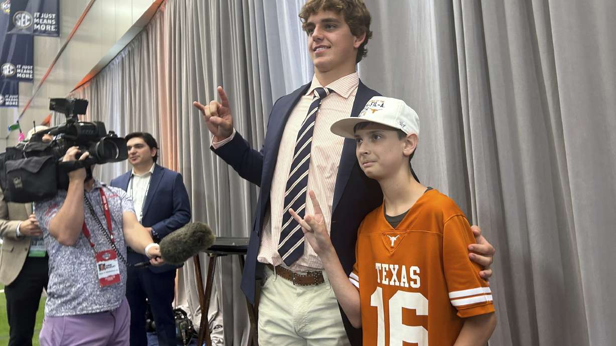 CORRECTS TO PETROZIELLO INSTEAD OF PETROZLELLO - Texas quarterback Arch Manning meets super-fan Connor Petroziello, 13, at SEC Media Days in Atlanta, Ga., Tuesday, July 15, 2025.