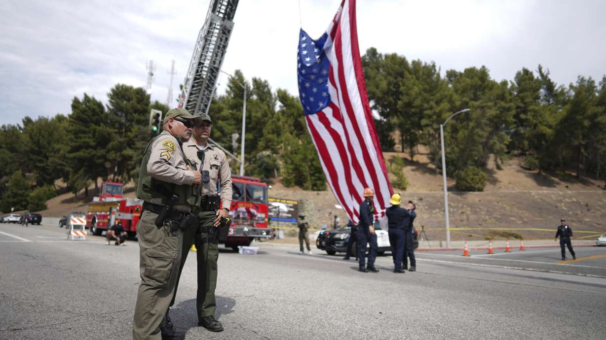 Sheriff's deputies along a procession route near where an explosion at a training facility killed three deputies on Friday in Los Angeles. Sheriff Robert Luna said it was the department's worst loss of life since 1857.