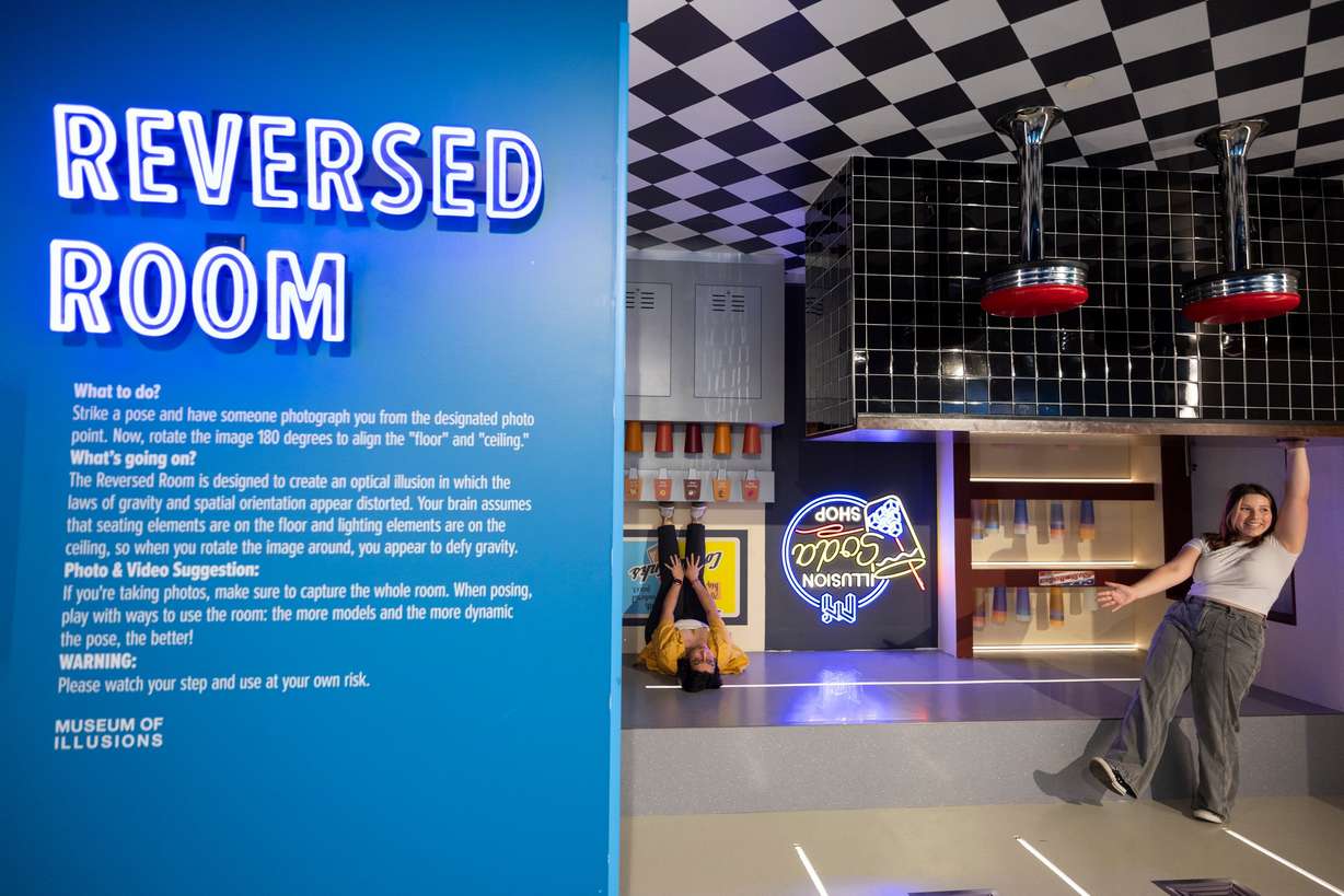 Lucas Davison, left, and Violet Stocking, right, pose for a photo at the Museum of Illusions in Salt Lake City on Thursday.