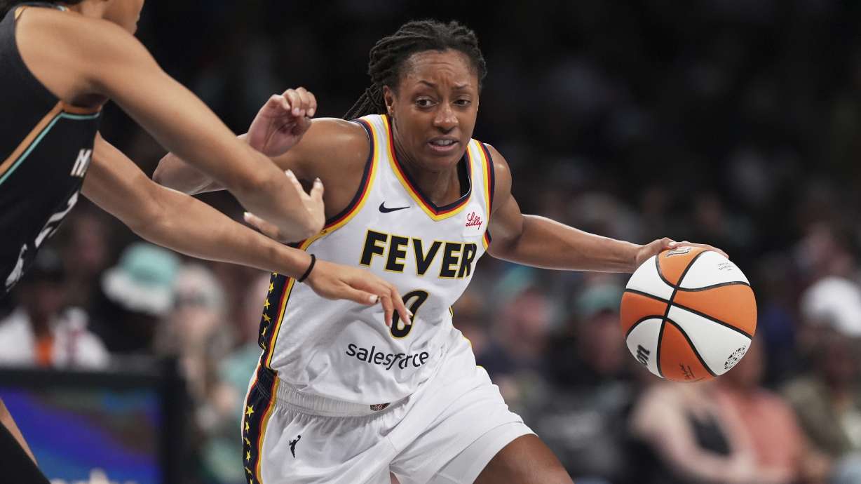 Indiana Fever's Kelsey Mitchell (0) drives past New York Liberty's Isabelle Harrison during the second half of a WNBA basketball game Wednesday, July 16, 2025, in New York.