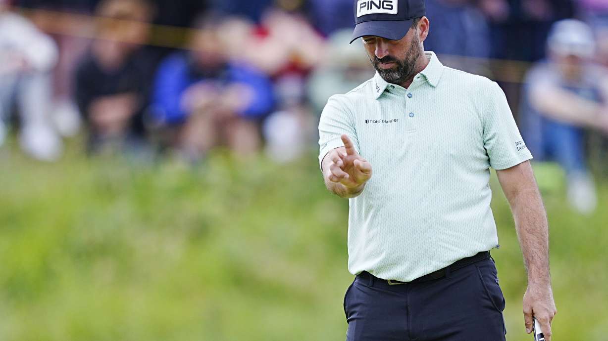 England's John Parry lines up a putt on the 2nd green during the third round of the British Open golf championship at the Royal Portrush Golf Club, Northern Ireland, Saturday, July 19, 2025.