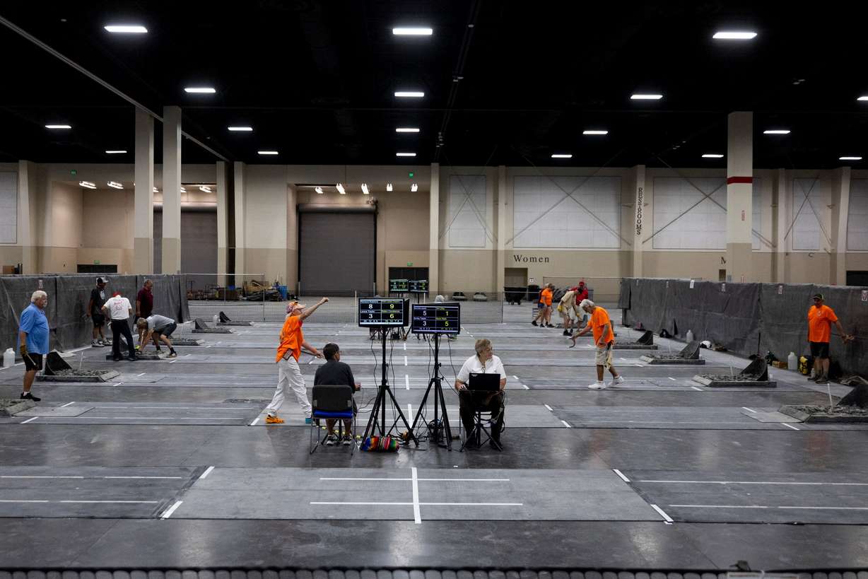 Competitors pitch horseshoes during a tournament at the Mountain America Expo Center in Sandy on Saturday.