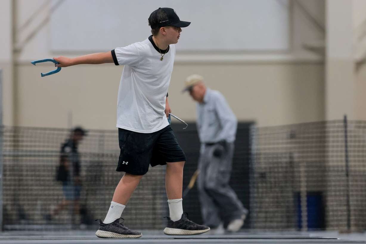 Ryker Matern, 12, of Tooele, grandson of Steven Gibson, pitches horseshoes at the Mountain America Expo Center in Sandy on Saturday.