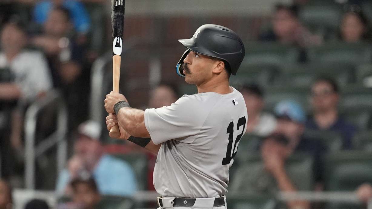 New York Yankees' Trent Grisham (12) hits a grand slam home run against the Atlanta Braves in the ninth inning of a baseball game, Saturday, July 19, 2025, in Atlanta.