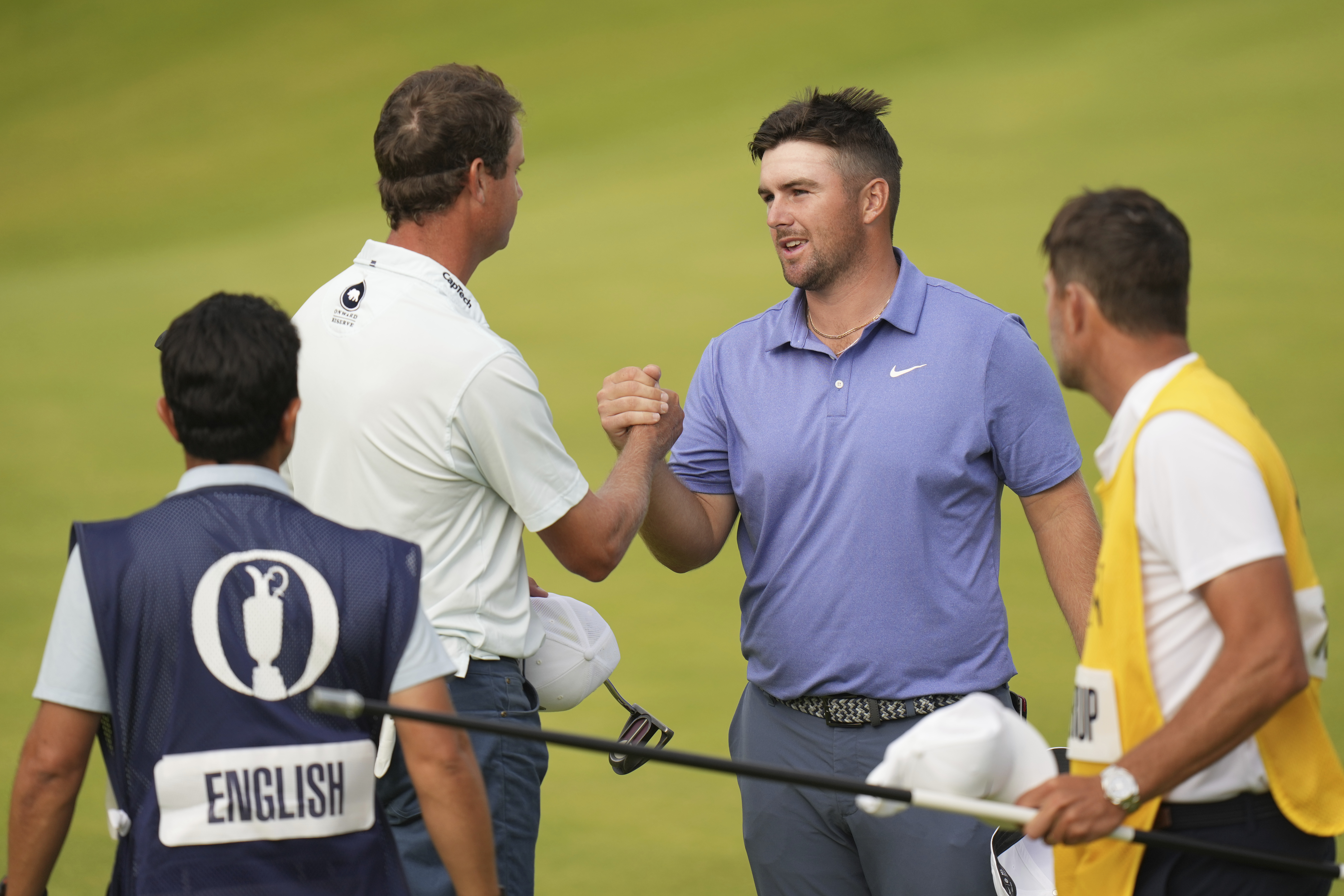Chris Gotterup of the United States, right and Harris English of the United States shake hands on the 18th green after completing their final round of the British Open golf championship at the Royal Portrush Golf Club, Northern Ireland, Sunday, July 20, 2025.
