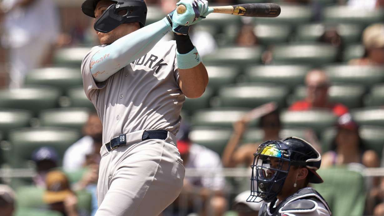 New York Yankees' Aaron Judge (99) hits a solo home run against the Atlanta Braves in the first inning of a baseball game, Sunday, July 20, 2025, in Atlanta.