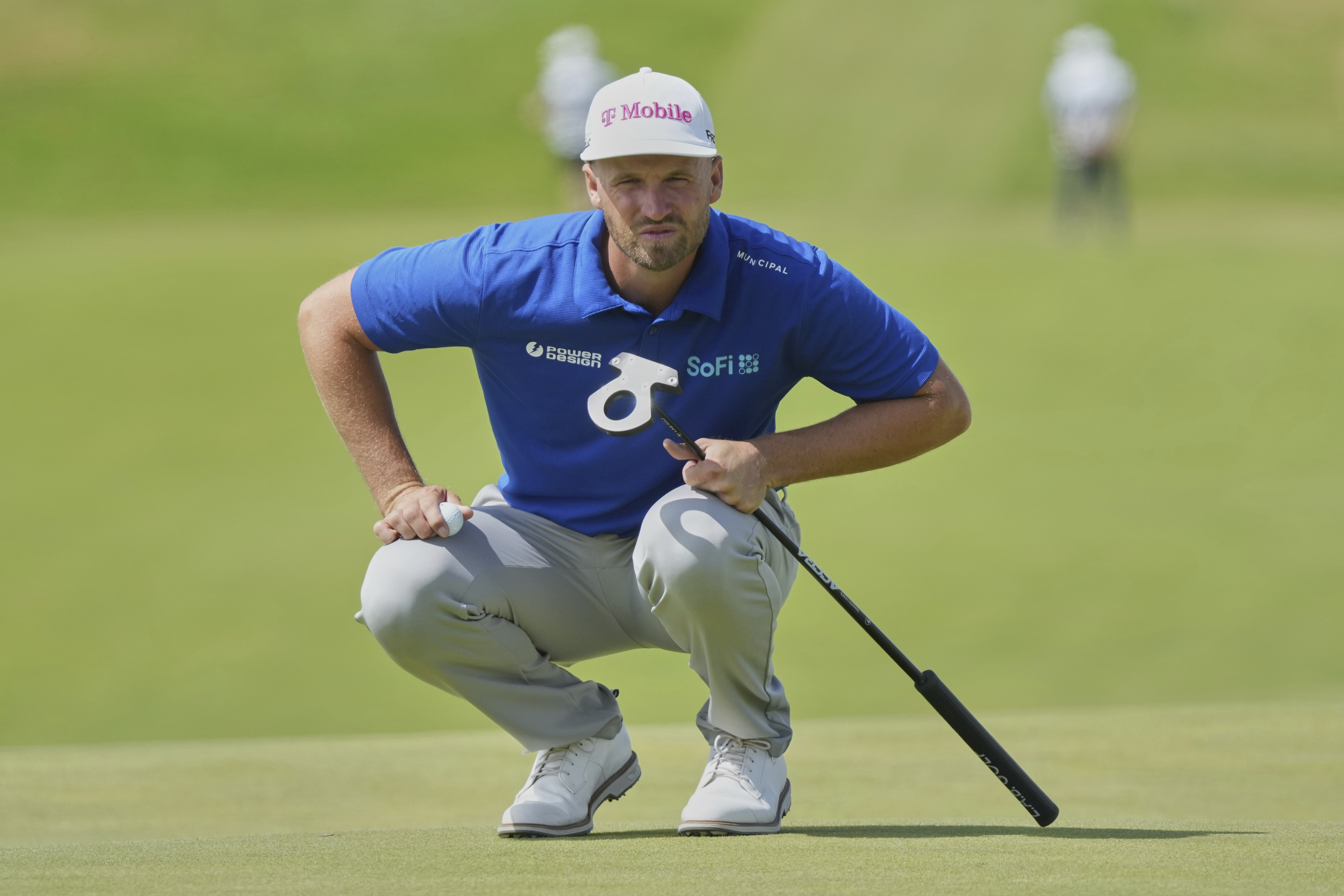 Wyndham Clark of the United States looks at the lie of his putt on the 1st green during the final round of the British Open golf championship at the Royal Portrush Golf Club, Northern Ireland, Sunday, July 20, 2025.