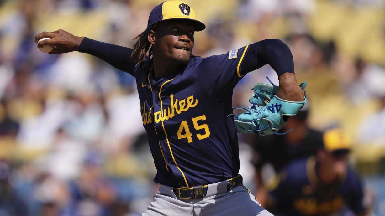 Milwaukee Brewers relief pitcher Abner Uribe throws to the plate during the ninth inning of a baseball game against the Los Angeles Dodgers, Sunday, July 20, 2025, in Los Angeles.