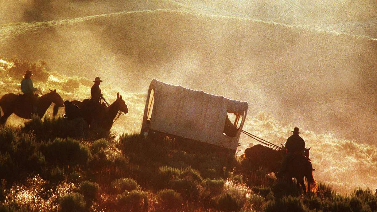 Wagons move through East Canyon during the Latter-day Saint pioneer trek reenactment in Utah in 1997. This week 178 years ago they started rolling in — the first non-Indians to enter the Salt Lake Valley and not keep going.