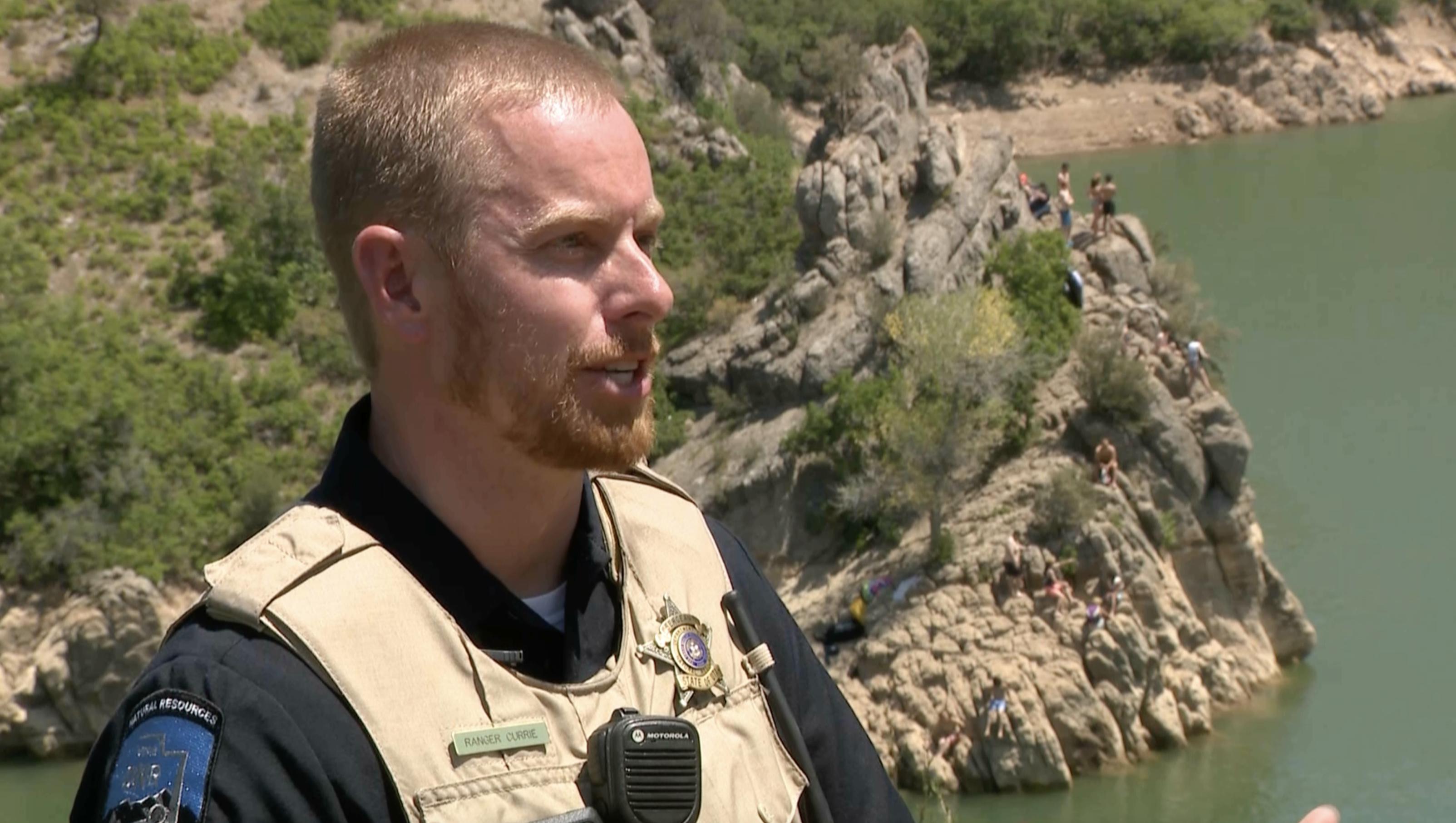 Sgt. Trent Currie of the Utah Department of Natural Resources Division of Law Enforcement talks about water safety at Causey Reservoir on Sunday. As investigators looked further into the death of a cliff jumper at Causey, state law enforcement officers urged people to wear their life jackets on bodies of water around Utah.