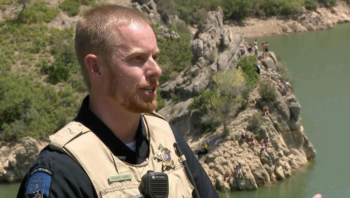 Sgt. Trent Currie of the Utah Department of Natural Resources Division of Law Enforcement talks about water safety at Causey Reservoir on Sunday. As investigators looked further into the death of a cliff jumper at Causey, state law enforcement officers urged people to wear their life jackets on bodies of water around Utah.
