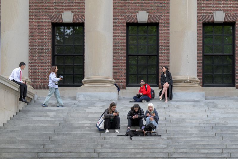 Students gather on the campus of Harvard University in Cambridge, Massachusetts, May 23.  Harvard will urge a federal judge on Monday to order President Trump's administration to restore about $2.5 billion in canceled federal grants.