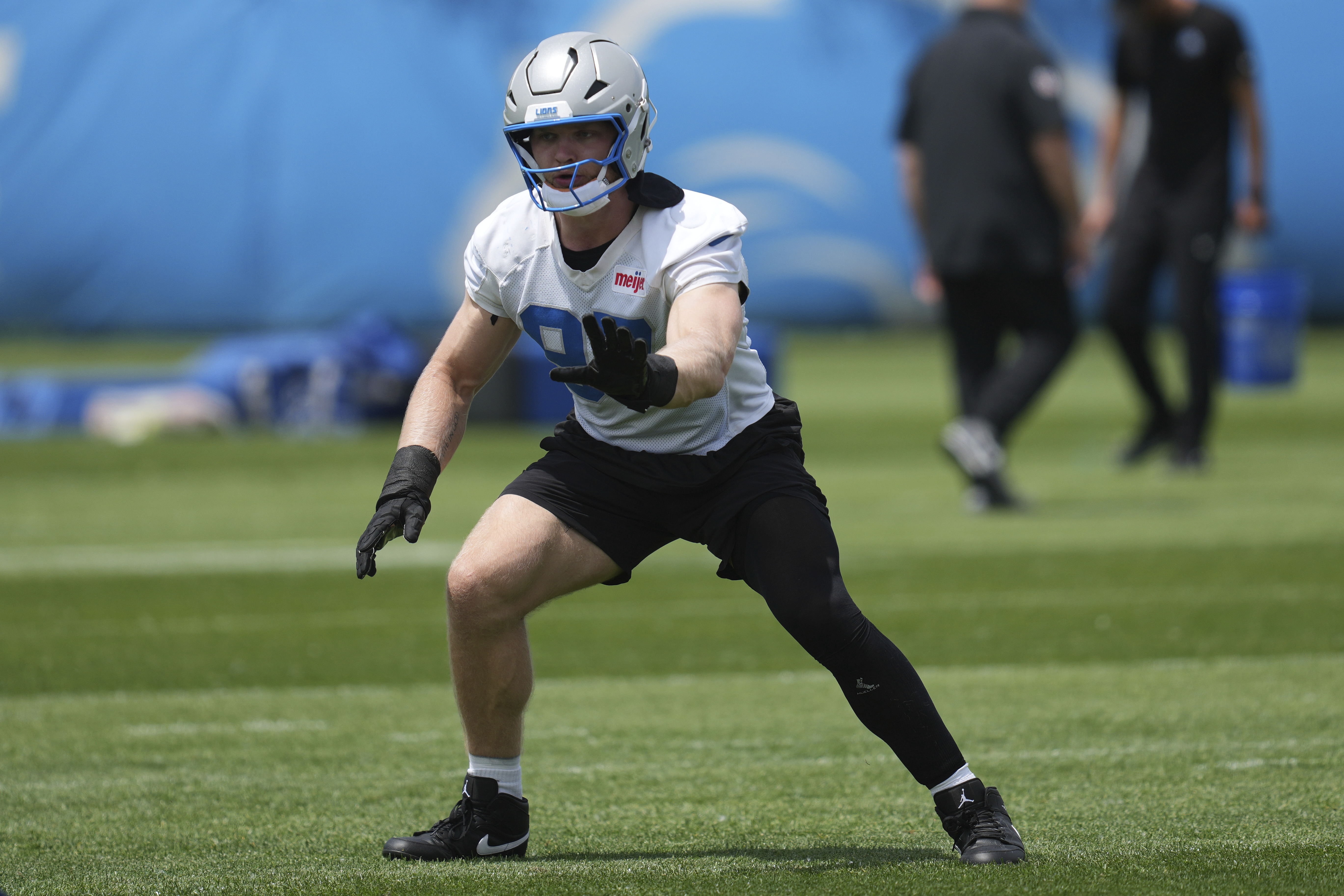 FILE - Detroit Lions defensive end Aidan Hutchinson runs a drill during an NFL football practice in Allen Park, Mich., May 30, 2025. 