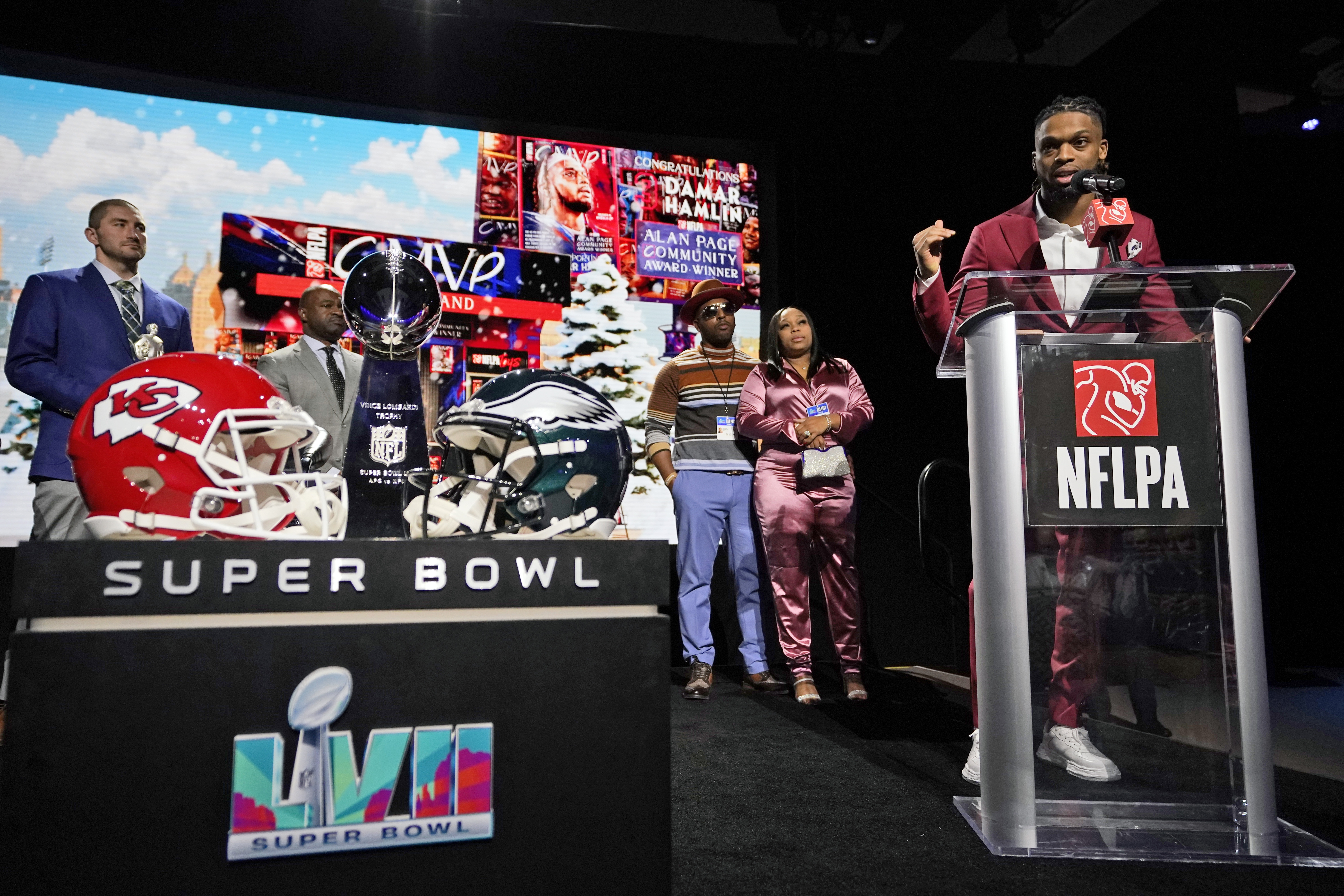FILE - Buffalo Bills' Damar Hamlin speaks after being introduced as the winner of the Alan Page Community Award during a news conference ahead of the Super Bowl 57 NFL football game Feb. 8, 2023, in Phoenix. Damar's parents Mario and Nina Hamlin, center, look on with NFLPA President JC Tretter, left. 