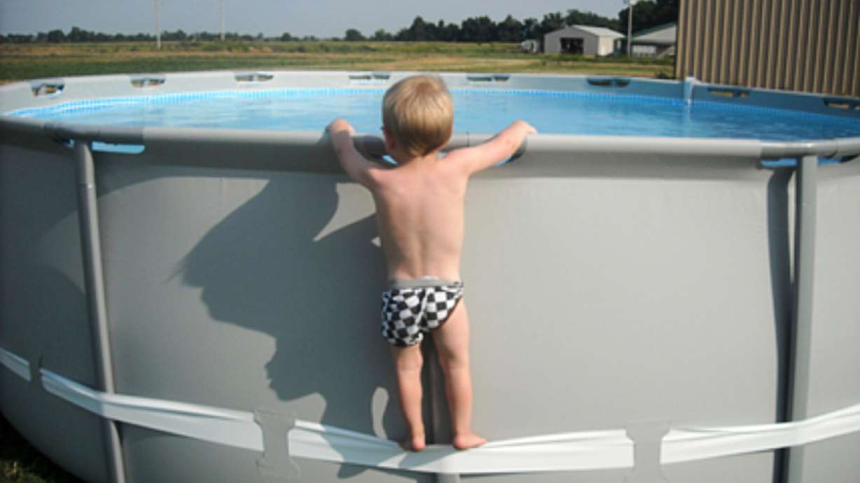 In this undated image provided by the CPSC, a child uses the compression strap to stand on above-ground pool.