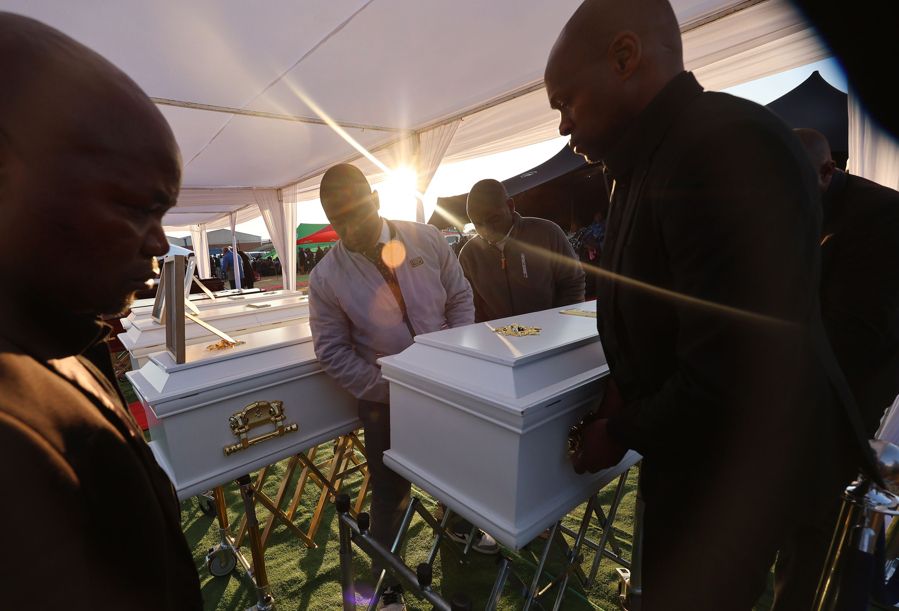 A casket is brought in during funeral services in Maputsoe, Lesotho, on Saturday, for 11 people killed in an auto accident. The Maputsoe Branch Young Women's church group was traveling to a district Young Women's activity when their minibus was involved in a multiple-vehicle collision.