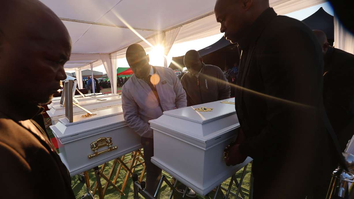 A casket is brought in during funeral services in Maputsoe, Lesotho, on Saturday, for 11 people killed in an auto accident. The Maputsoe Branch Young Women's church group was traveling to a district Young Women's activity when their minibus was involved in a multiple-vehicle collision.
