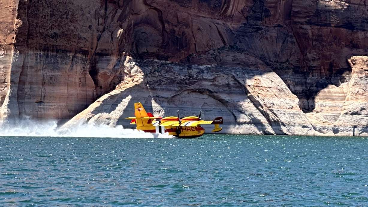 A fixed-wing Super Scooper takes water from Lake Powell. Glen Canyon National Recreation Area officials are urging boaters to be cautious as firefighters scoop up water from the reservoir to fight nearby wildfires.