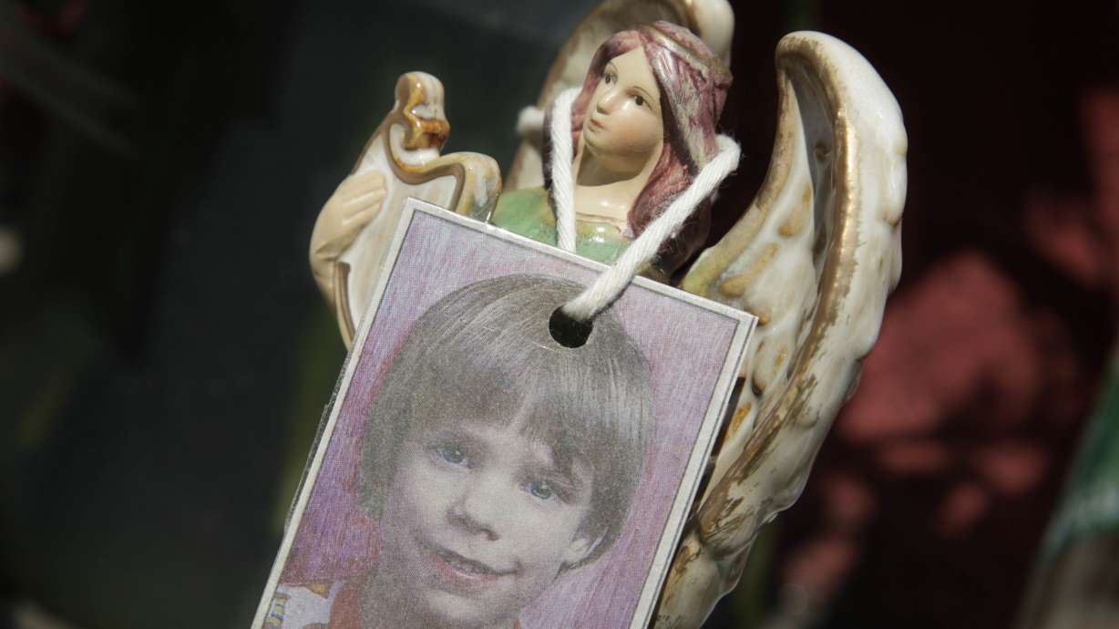 A photograph of Etan Patz hangs on an angel figurine, as part of a makeshift memorial in the SoHo neighborhood of New York, May 28, 2012.
