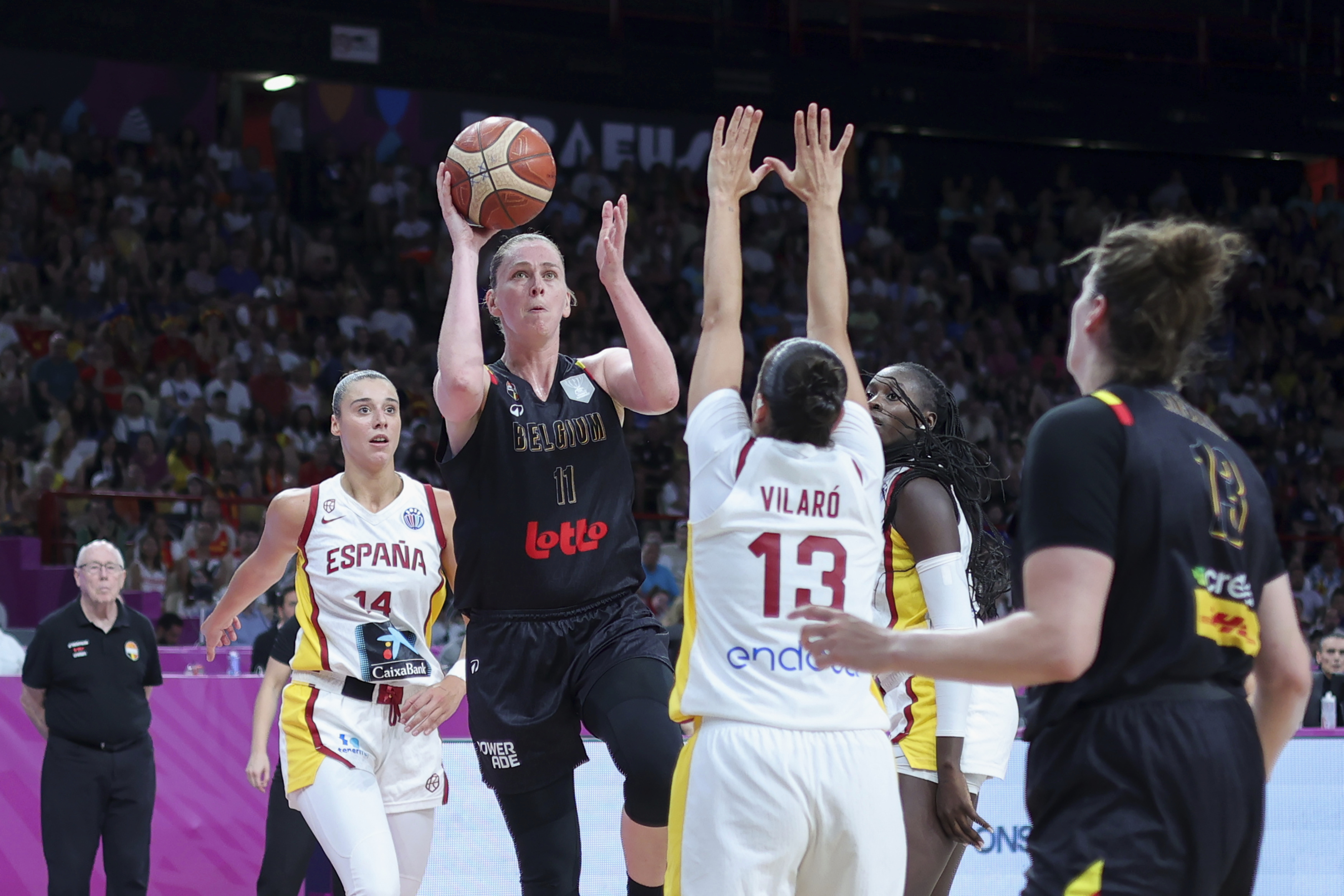 Belgium's Emma Meesseman, center, tries to score against Spain's Andrea Vilaro, during the FIBA Women's EuroBasket 2025 final match between Spain and Belgium at the Peace and Friendship Stadium in Piraeus near Athens, Greece, Sunday, June 29, 2025.