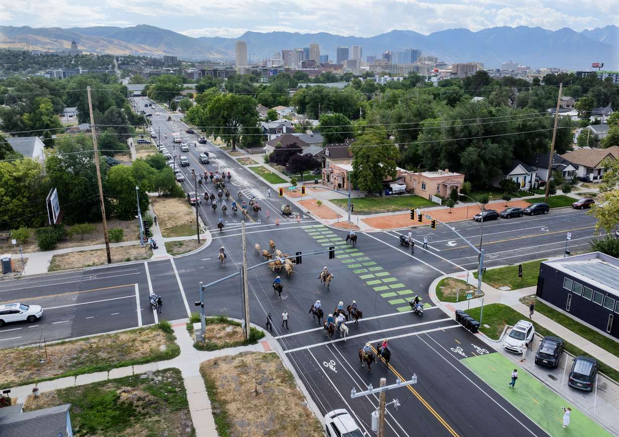 With downtown Salt Lake City in the background, Gov. Spencer Cox and first lady Abby Cox and others kick off the Days of '47 with the annual longhorn cattle drive in Salt Lake City on Monday.
