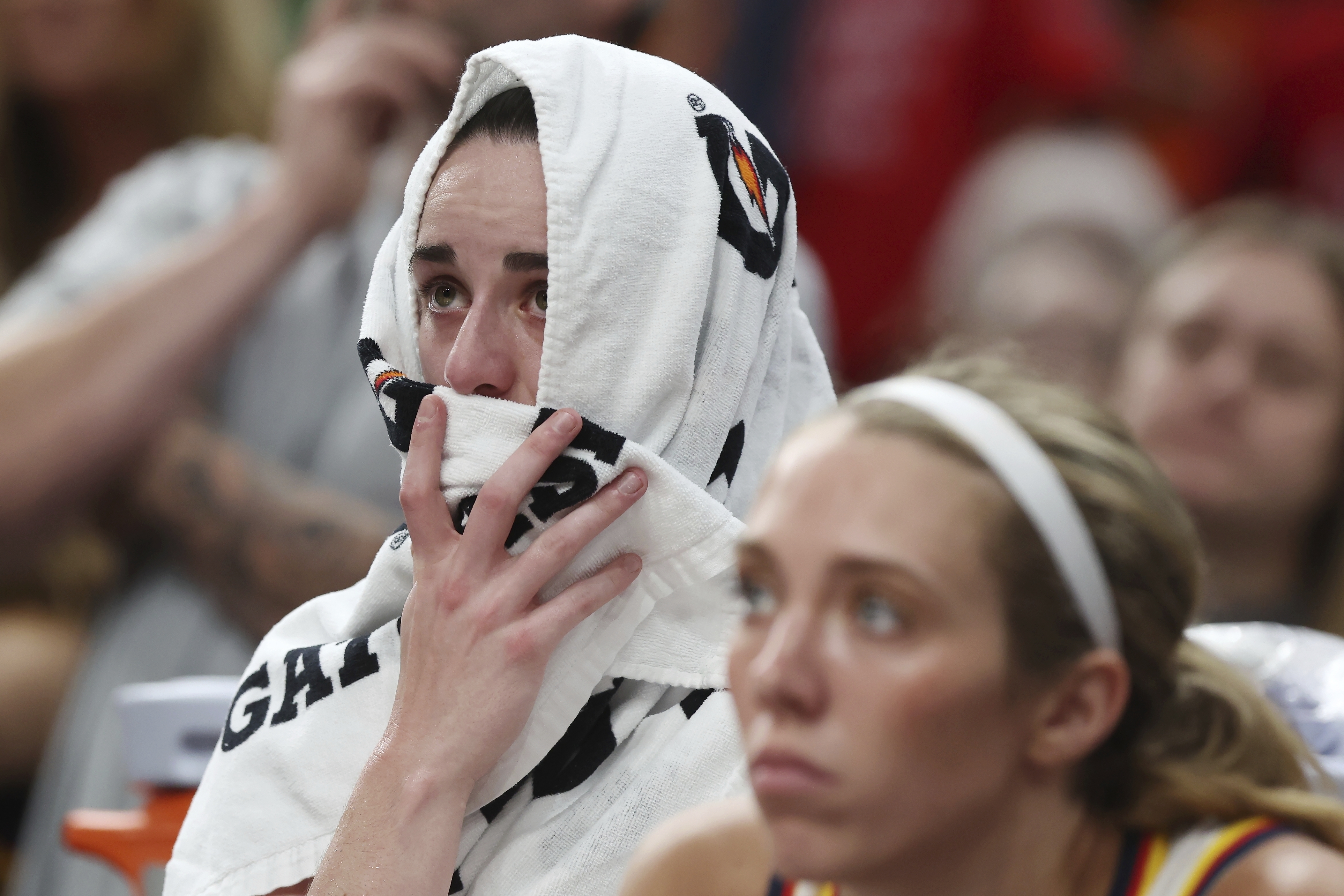 Indiana Fever's Caitlin Clark sits on the bench after an apparent injury during the second half of a WNBA basketball game against the Connecticut Sun, Tuesday, July 15, 2025, in Boston. 