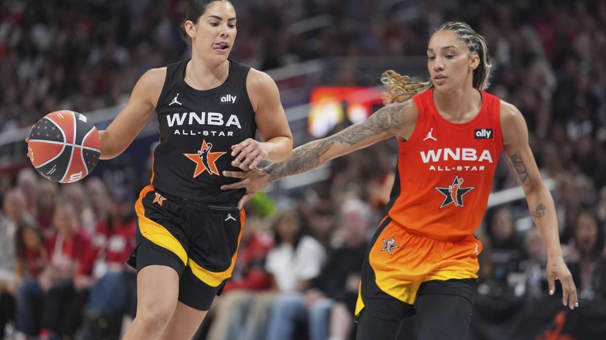Los Angeles Sparks's Kelsey Plum, left, goes to the basket against Seattle Storm's Gabby Williams during the second half of a WNBA All-Star basketball game, Saturday, July 19, 2025, in Indianapolis.