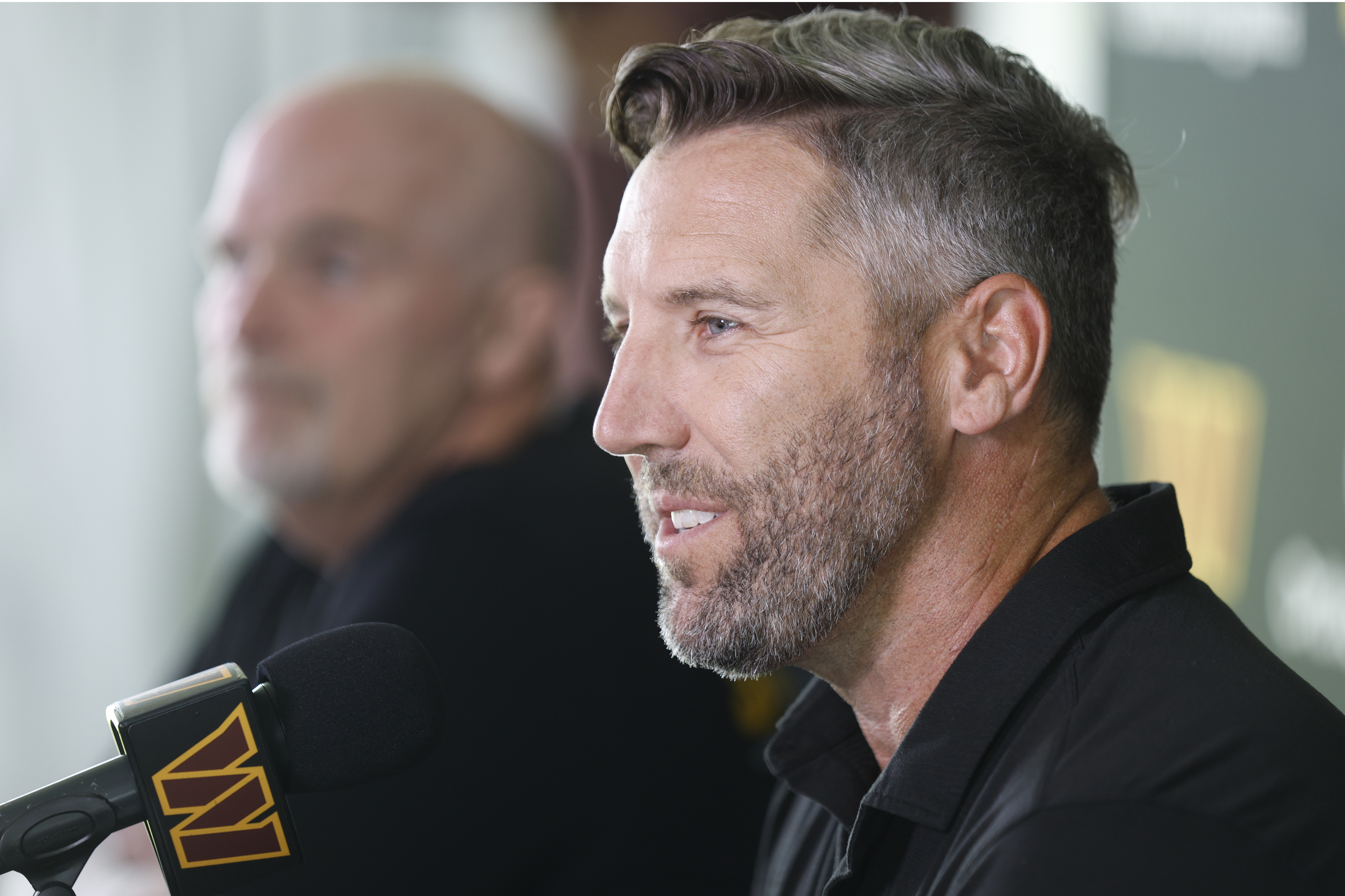 Washington Commanders general manager Adam Peters, right, speaks as head coach Dan Quinn, left, looks on during a news conference at the NFL football team's training camp in Ashburn, Va., Tuesday, July 22, 2025. 