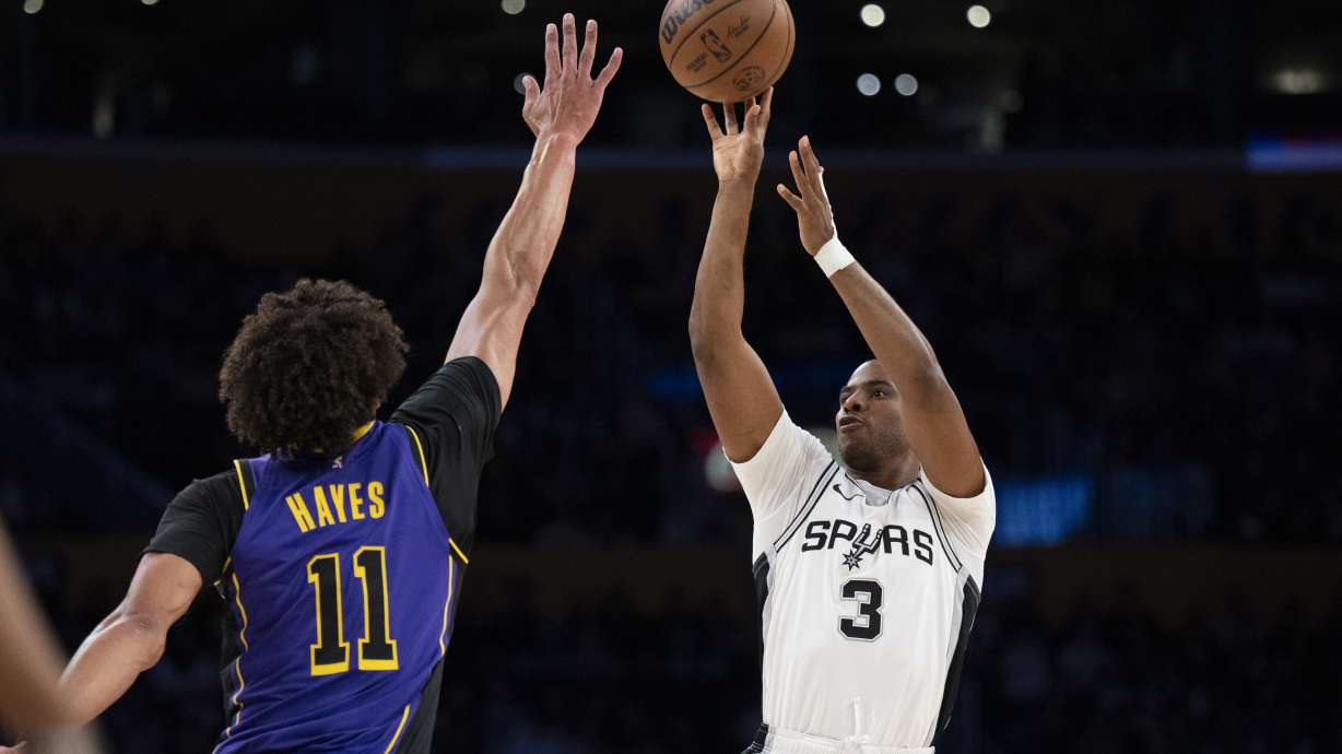 FILE - San Antonio Spurs guard Chris Paul (3) shoots over Los Angeles Lakers center Jaxson Hayes (11) during the first half of an NBA basketball game in Los Angeles, March 17, 2025.