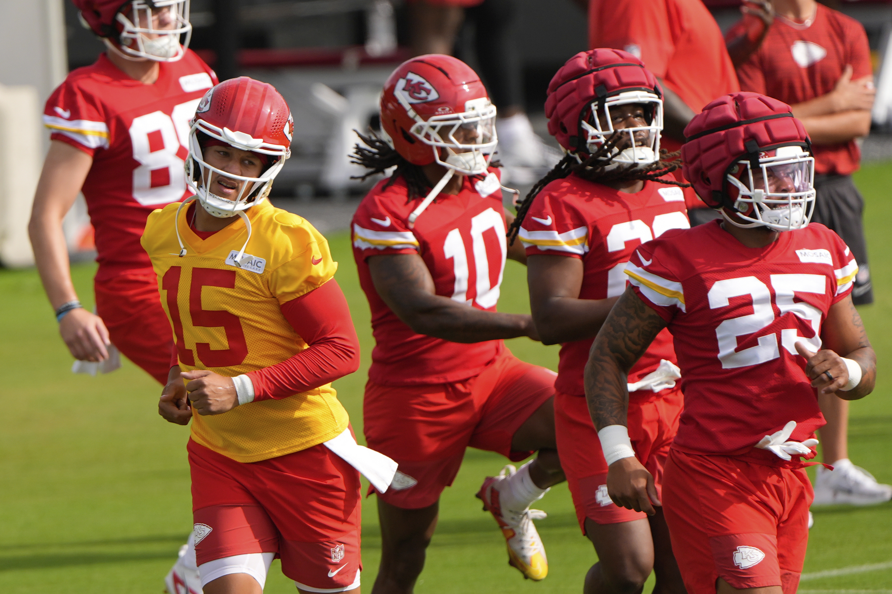 Kansas City Chiefs quarterback Patrick Mahomes (15) runs with teammates at NFL football training camp Tuesday, July 22, 2025, in St. Joseph, Mo. 