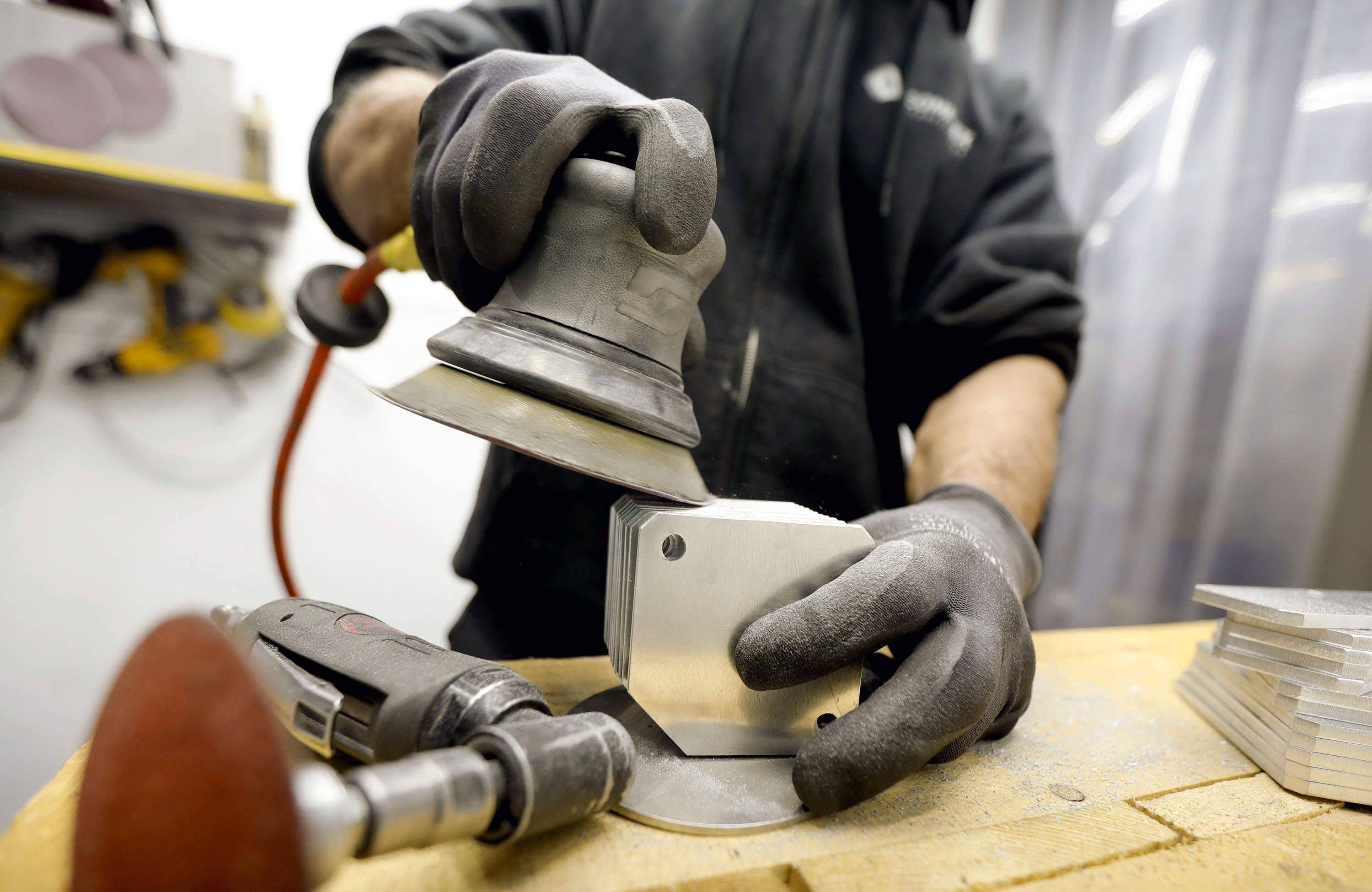 Operator Ducke Neyugn deburrs brackets for a flight simulator tower at Complex Fabricators on April 6, 2021. The Columbus Foundation has partnered with SLCC and the Utah Manufacturers Association to pilot the Utah Uniquely Abled Machinist Program.